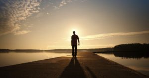 13235-man-alone-walks-water-path-road-sky-clouds-horizon-1200w-tn