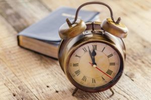 depositphotos_47016701-stock-photo-clock-and-bible-on-wood