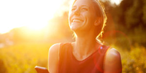 Young woman using smart phone at sunset